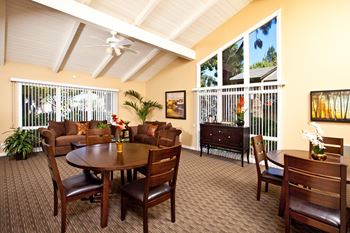 a living room with a table and chairs